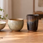 Wide, rounded, tall and flared ceramic tea cup shapes arranged side by side